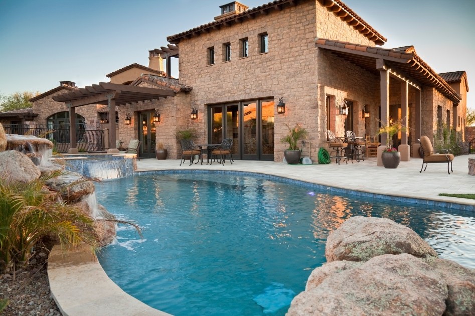 San Antonio residential exterior with pool and covered patio at dusk
